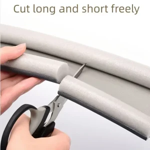 Cutting a foam draft stopper strip to length with scissors